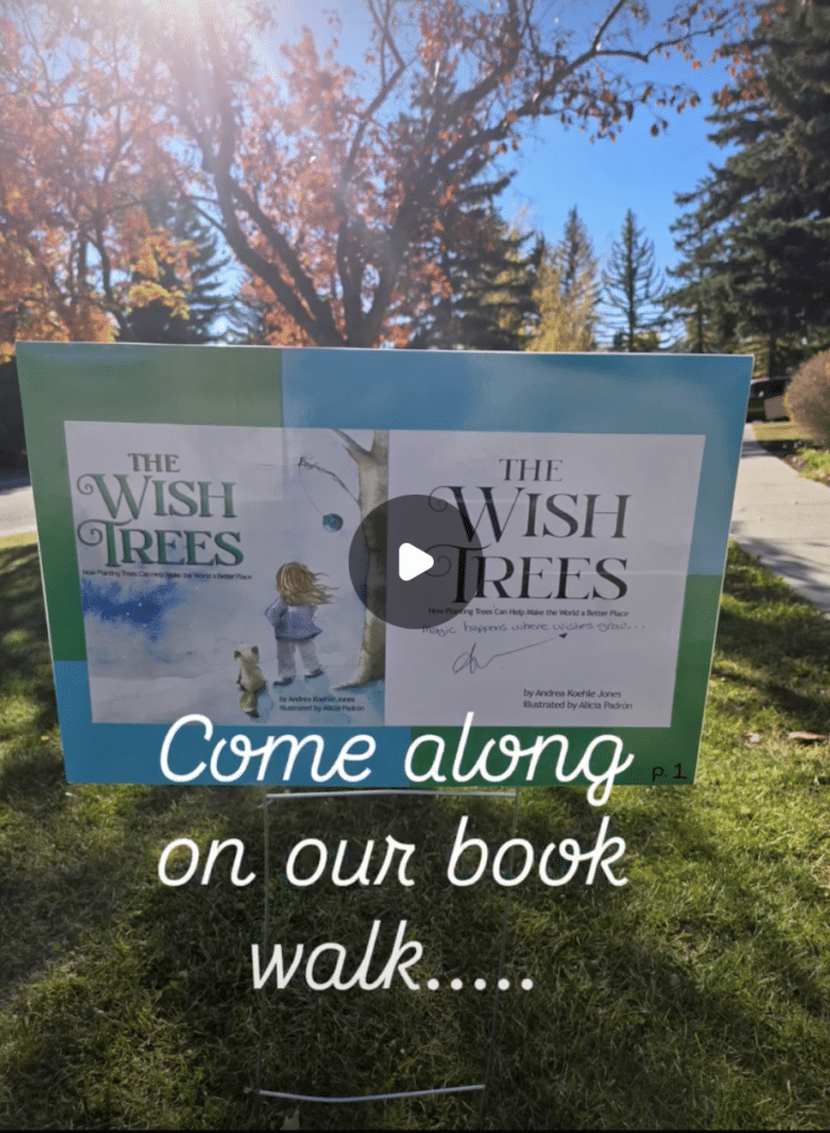 Copy The Wish Trees children's book displayed on an outdoor StoryWalk sign at Prince of Wales School in Calgary